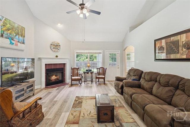 133 Cobbleton Dr, Rincon, GA 31326 - living area featuring arched walkways, a ceiling fan, wood finished floors, high vaulted ceiling, and a tiled fireplace