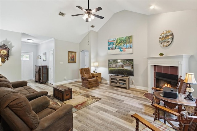 133 Cobbleton Dr, Rincon, GA 31326 - living area with a ceiling fan, light wood-style floors, arched walkways, a tile fireplace, and baseboards