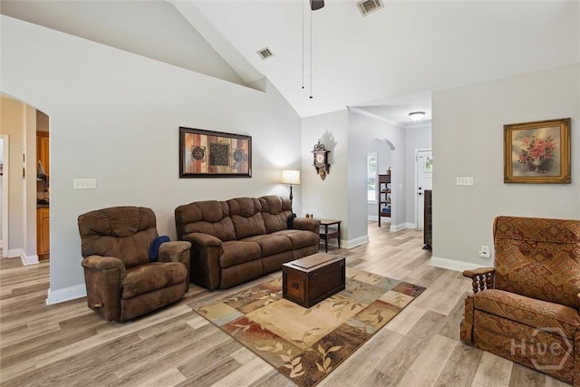 133 Cobbleton Dr, Rincon, GA 31326 - living room featuring arched walkways, a ceiling fan, light wood finished floors, baseboards, and high vaulted ceiling