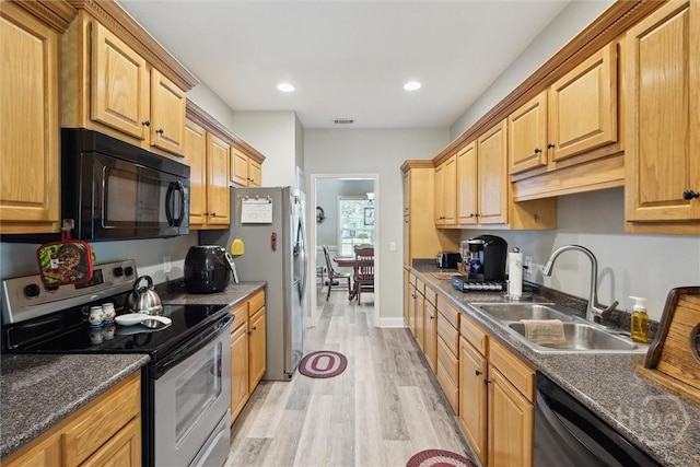 133 Cobbleton Dr, Rincon, GA 31326 - kitchen with black appliances, a sink, light wood-type flooring, dark countertops, and recessed lighting