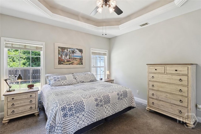 133 Cobbleton Dr, Rincon, GA 31326 - bedroom with dark colored carpet, multiple windows, baseboards, and a tray ceiling