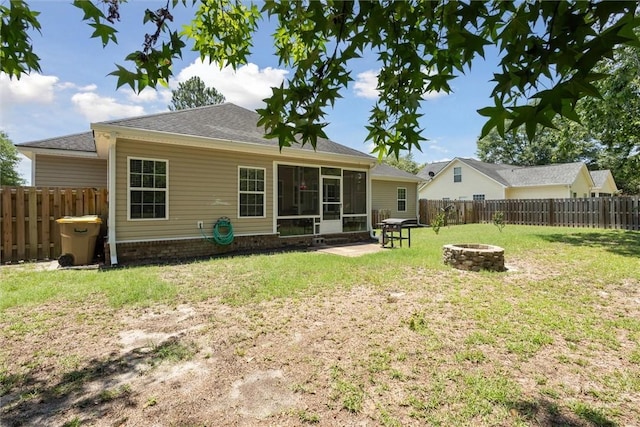 133 Cobbleton Dr, Rincon, GA 31326 - back of property with a fire pit, a sunroom, and a shingled roof