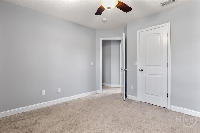 42 Kinlock Ct, Midway, GA 31320 - unfurnished bedroom with light colored carpet, baseboards, ceiling fan, and a textured ceiling