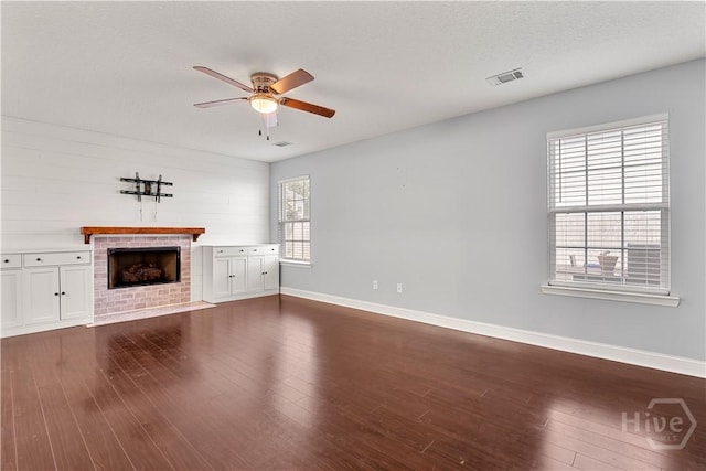 42 Kinlock Ct, Midway, GA 31320 - unfurnished living room featuring a ceiling fan, a fireplace, baseboards, and dark wood finished floors
