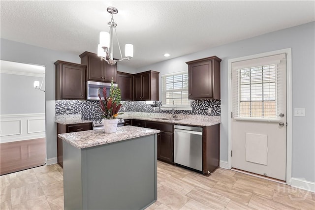 42 Kinlock Ct, Midway, GA 31320 - kitchen with appliances with stainless steel finishes, a chandelier, dark brown cabinets, decorative backsplash, and a sink