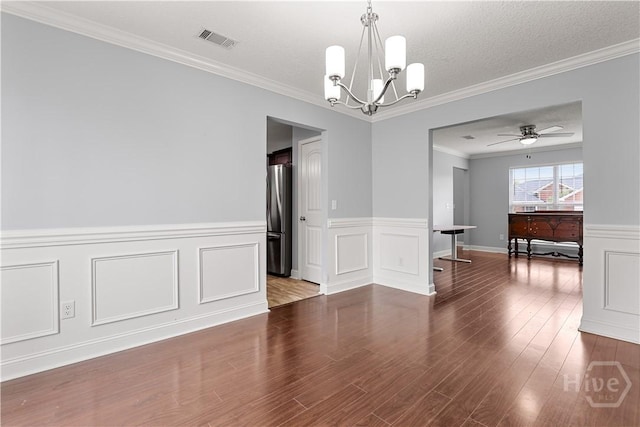 42 Kinlock Ct, Midway, GA 31320 - unfurnished room featuring a chandelier, wood finished floors, ornamental molding, a wainscoted wall, and a ceiling fan