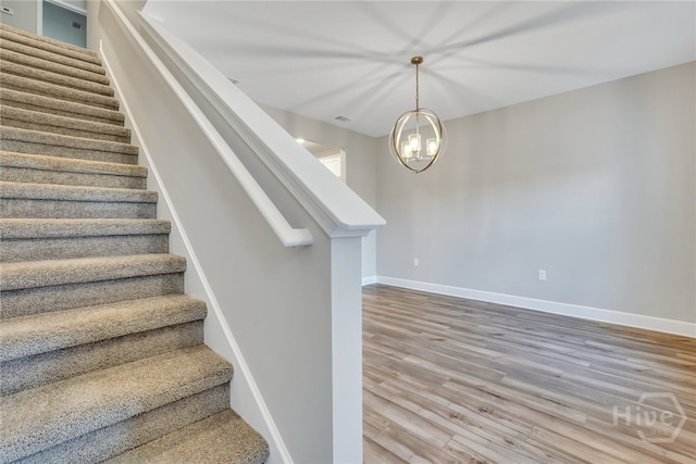 238 Haisley Run, Guyton, GA 31312 - staircase with wood finished floors, a chandelier, and baseboards