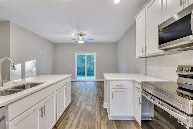 238 Haisley Run, Guyton, GA 31312 - kitchen featuring stainless steel appliances, a sink, tasteful backsplash, ceiling fan, and light wood-style flooring