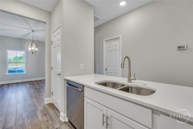238 Haisley Run, Guyton, GA 31312 - kitchen with stainless steel dishwasher, a sink, light countertops, white cabinets, and wood finished floors