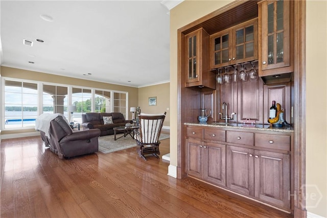 745 S Chickasaw Trl, Sparta, GA 31087 - indoor wet bar with wood finished floors, baseboards, and crown molding