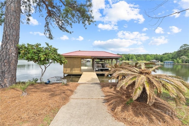 745 S Chickasaw Trl, Sparta, GA 31087 - view of front of home with a dock, a water view, boat lift, and metal roof