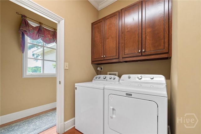 745 S Chickasaw Trl, Sparta, GA 31087 - laundry room featuring separate washer and dryer, cabinet space, baseboards, ornamental molding, and light wood finished floors