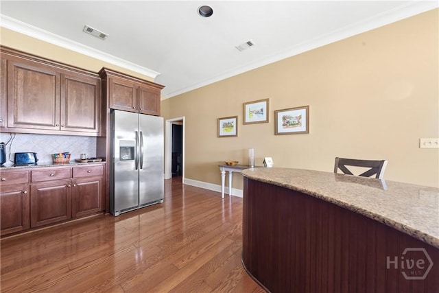 745 S Chickasaw Trl, Sparta, GA 31087 - kitchen featuring stainless steel fridge, crown molding, dark wood finished floors, decorative backsplash, and baseboards