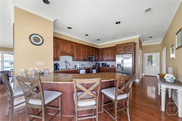 745 S Chickasaw Trl, Sparta, GA 31087 - kitchen with stainless steel appliances, dark wood-style flooring, plenty of natural light, and ornamental molding