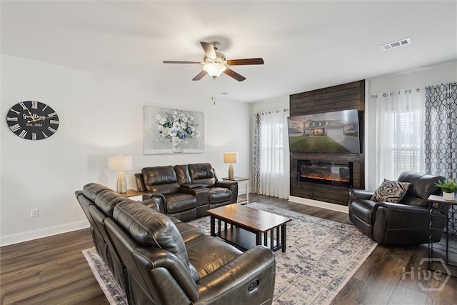 109 Finch Ln, Guyton, GA 31312 - living room with a ceiling fan, dark wood-style flooring, baseboards, and a large fireplace