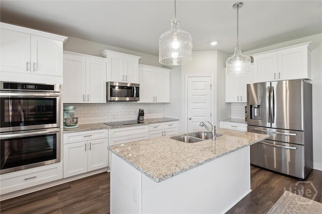 109 Finch Ln, Guyton, GA 31312 - kitchen with stainless steel appliances, a sink, tasteful backsplash, and dark wood-type flooring