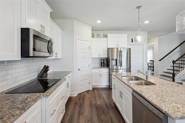 109 Finch Ln, Guyton, GA 31312 - kitchen with stainless steel appliances, a sink, a center island with sink, white cabinets, and dark wood-style floors