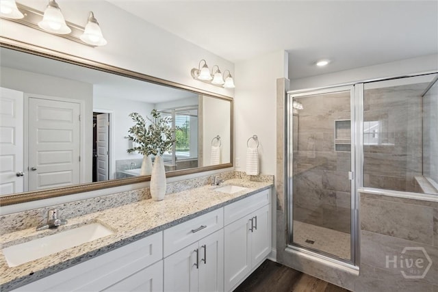 109 Finch Ln, Guyton, GA 31312 - full bath with double vanity, a shower stall, wood finished floors, and a closet