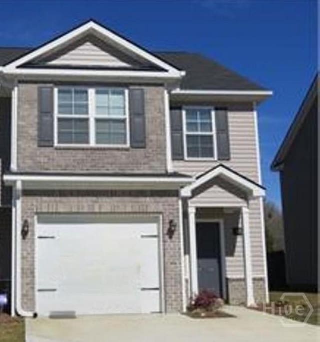60 Kepler Loop, Richmond Hill, GA 31324 - view of front of property with a garage, brick siding, and concrete driveway