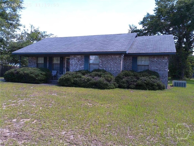 41 Crosby Dr, Hinesville, GA 31313 - ranch-style home with a front yard and central air condition unit