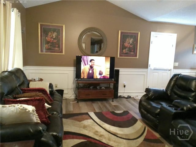 41 Crosby Dr, Hinesville, GA 31313 - living room with wood finished floors, lofted ceiling, a wainscoted wall, and a decorative wall