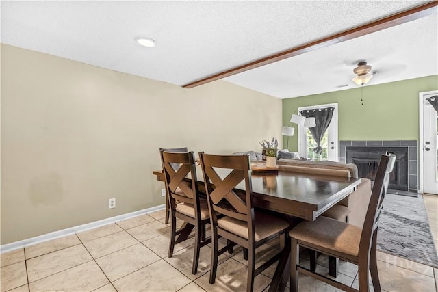 727 S Main St Unit 117, Hinesville, GA 31313 - dining space with ceiling fan, light tile patterned floors, a fireplace, and baseboards