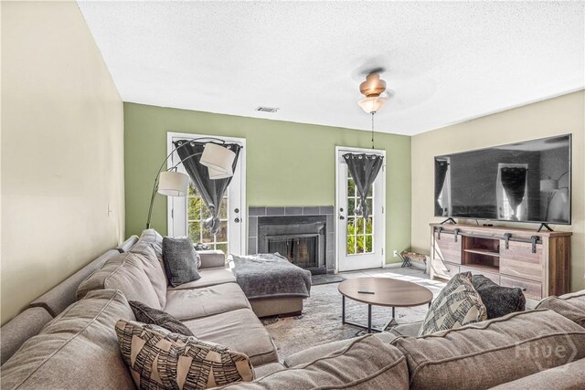 727 S Main St Unit 117, Hinesville, GA 31313 - living area featuring a fireplace and a textured ceiling