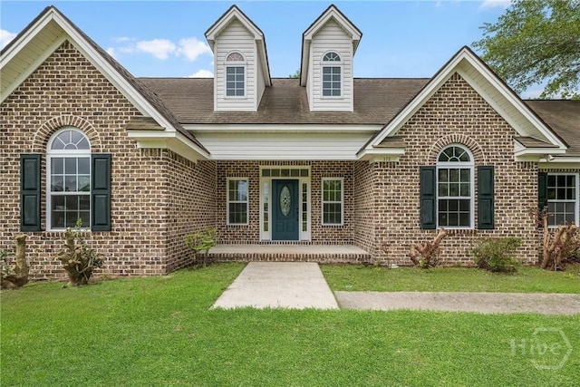 172 Jamestown Dr, Rincon, GA 31326 - view of front of house featuring brick siding, a front lawn, a shingled roof, and a porch
