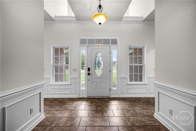 172 Jamestown Dr, Rincon, GA 31326 - foyer with a decorative wall, crown molding, and a wainscoted wall