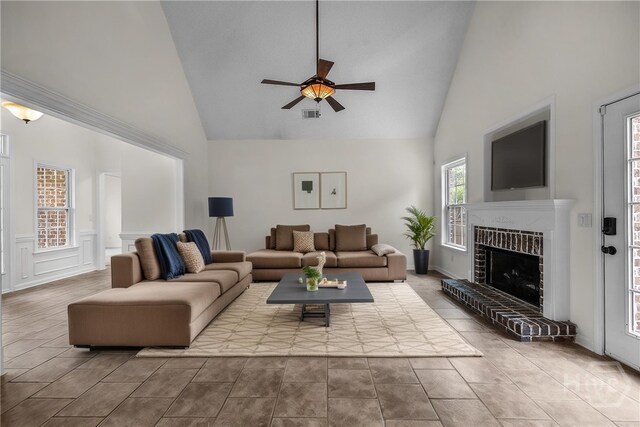 172 Jamestown Dr, Rincon, GA 31326 - living area featuring high vaulted ceiling, a ceiling fan, a fireplace, and tile patterned floors
