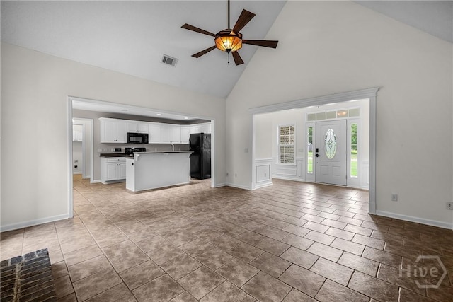 172 Jamestown Dr, Rincon, GA 31326 - unfurnished living room with high vaulted ceiling, a ceiling fan, baseboards, and light tile patterned flooring