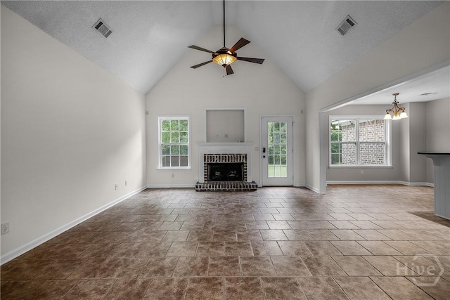 172 Jamestown Dr, Rincon, GA 31326 - unfurnished living room featuring a fireplace, a ceiling fan, a chandelier, high vaulted ceiling, and baseboards