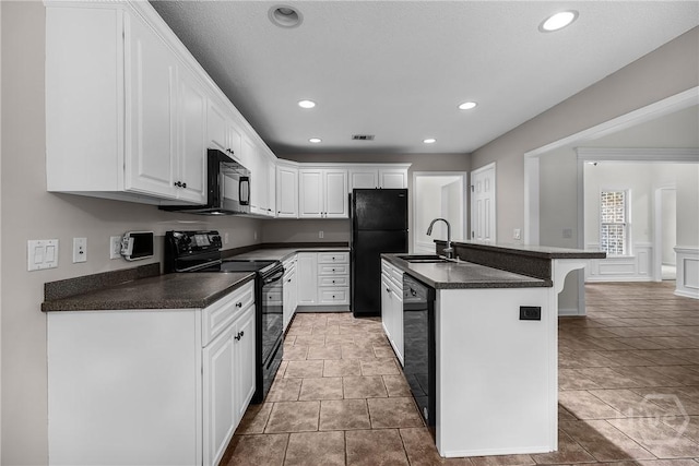 172 Jamestown Dr, Rincon, GA 31326 - kitchen featuring black appliances, a sink, dark countertops, white cabinets, and recessed lighting