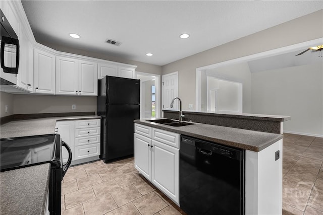 172 Jamestown Dr, Rincon, GA 31326 - kitchen featuring black appliances, a sink, dark countertops, white cabinetry, and a kitchen island with sink