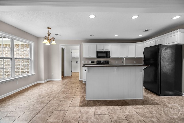 172 Jamestown Dr, Rincon, GA 31326 - kitchen featuring black appliances, a chandelier, dark countertops, white cabinetry, and decorative light fixtures
