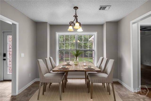 172 Jamestown Dr, Rincon, GA 31326 - dining room featuring a textured ceiling and baseboards