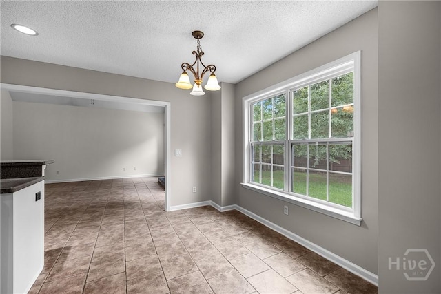 172 Jamestown Dr, Rincon, GA 31326 - empty room featuring a textured ceiling, a chandelier, tile patterned floors, baseboards, and recessed lighting