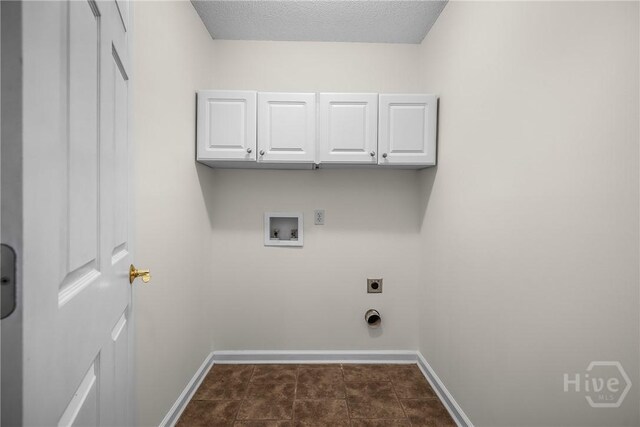 172 Jamestown Dr, Rincon, GA 31326 - laundry area featuring cabinet space, hookup for a washing machine, baseboards, electric dryer hookup, and a textured ceiling