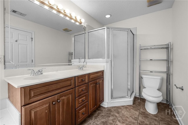 172 Jamestown Dr, Rincon, GA 31326 - bathroom with double vanity, toilet, a shower stall, tile patterned flooring, and a textured ceiling