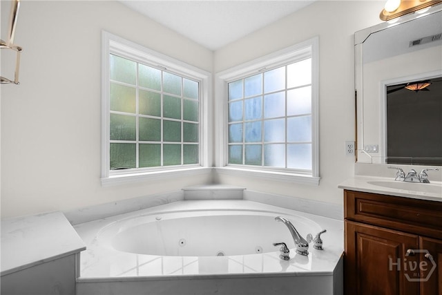 172 Jamestown Dr, Rincon, GA 31326 - bathroom with vanity, plenty of natural light, and a jetted tub