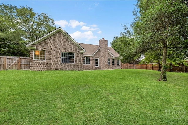172 Jamestown Dr, Rincon, GA 31326 - rear view of property with a chimney and brick siding