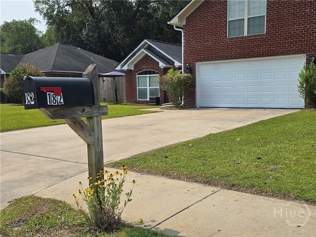 182 Gloucester Dr, Midway, GA 31320 - exterior view of brick siding, concrete driveway, and a downspout