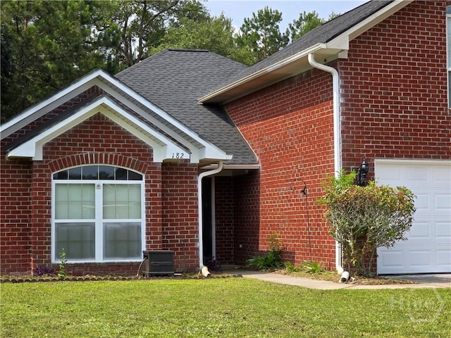 182 Gloucester Dr, Midway, GA 31320 - view of front of home featuring brick siding, a front yard, a garage, and roof with shingles