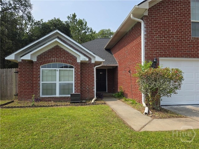 182 Gloucester Dr, Midway, GA 31320 - view of front of house with brick siding, central AC unit, and a garage