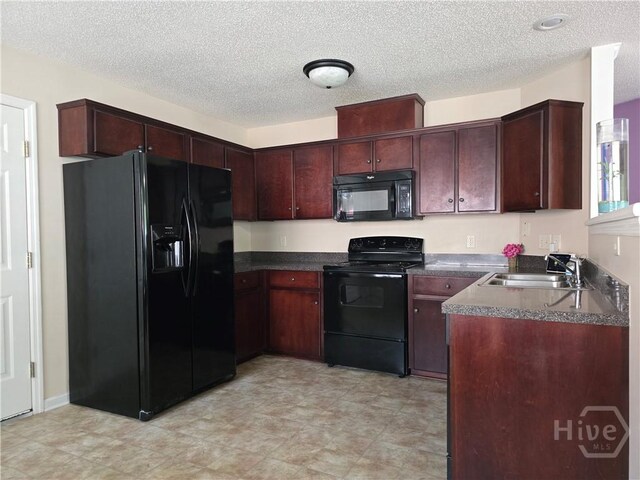 182 Gloucester Dr, Midway, GA 31320 - kitchen with black appliances, a sink, dark countertops, and a textured ceiling