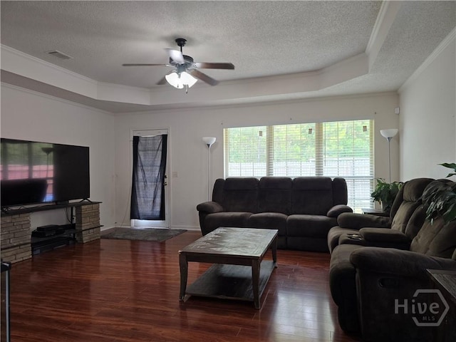 182 Gloucester Dr, Midway, GA 31320 - living area with a textured ceiling, a raised ceiling, wood finished floors, ornamental molding, and a ceiling fan