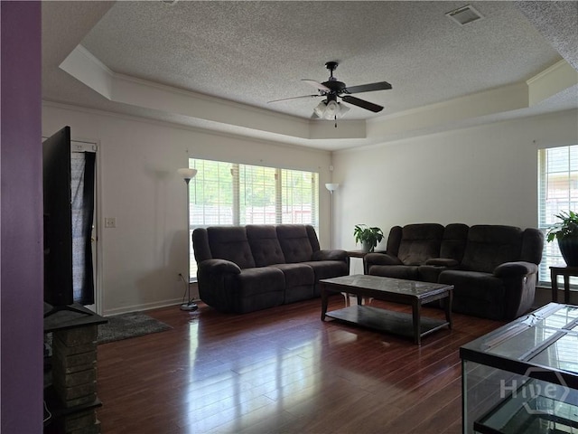 182 Gloucester Dr, Midway, GA 31320 - living room featuring a raised ceiling, a textured ceiling, a ceiling fan, dark wood finished floors, and crown molding