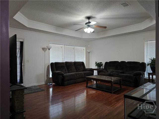 182 Gloucester Dr, Midway, GA 31320 - living room with a tray ceiling, a ceiling fan, ornamental molding, wood finished floors, and a textured ceiling