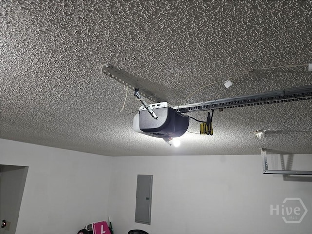 182 Gloucester Dr, Midway, GA 31320 - garage view of electric panel, a garage door opener, and a textured ceiling