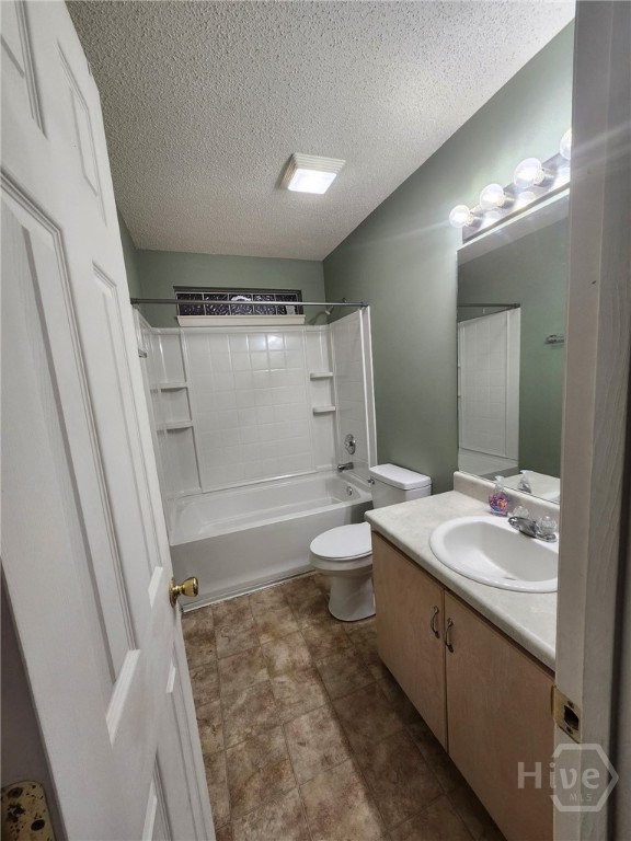 182 Gloucester Dr, Midway, GA 31320 - full bath featuring vanity, a textured ceiling, and bathtub / shower combination